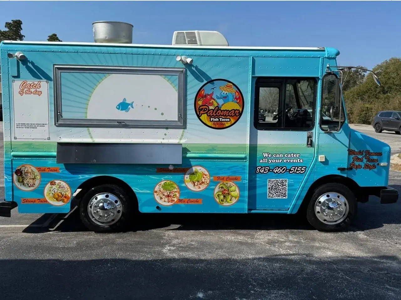 The Palomar Fish Tacos food truck, wrapped in ocean-blue branding with the Palomar logo